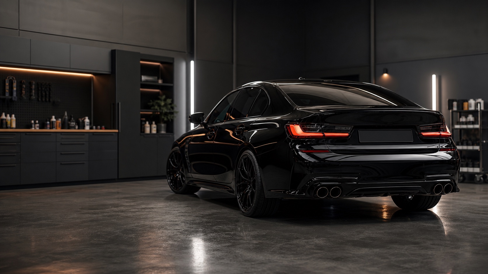 Black vehicle inside a professional car detailing workshop